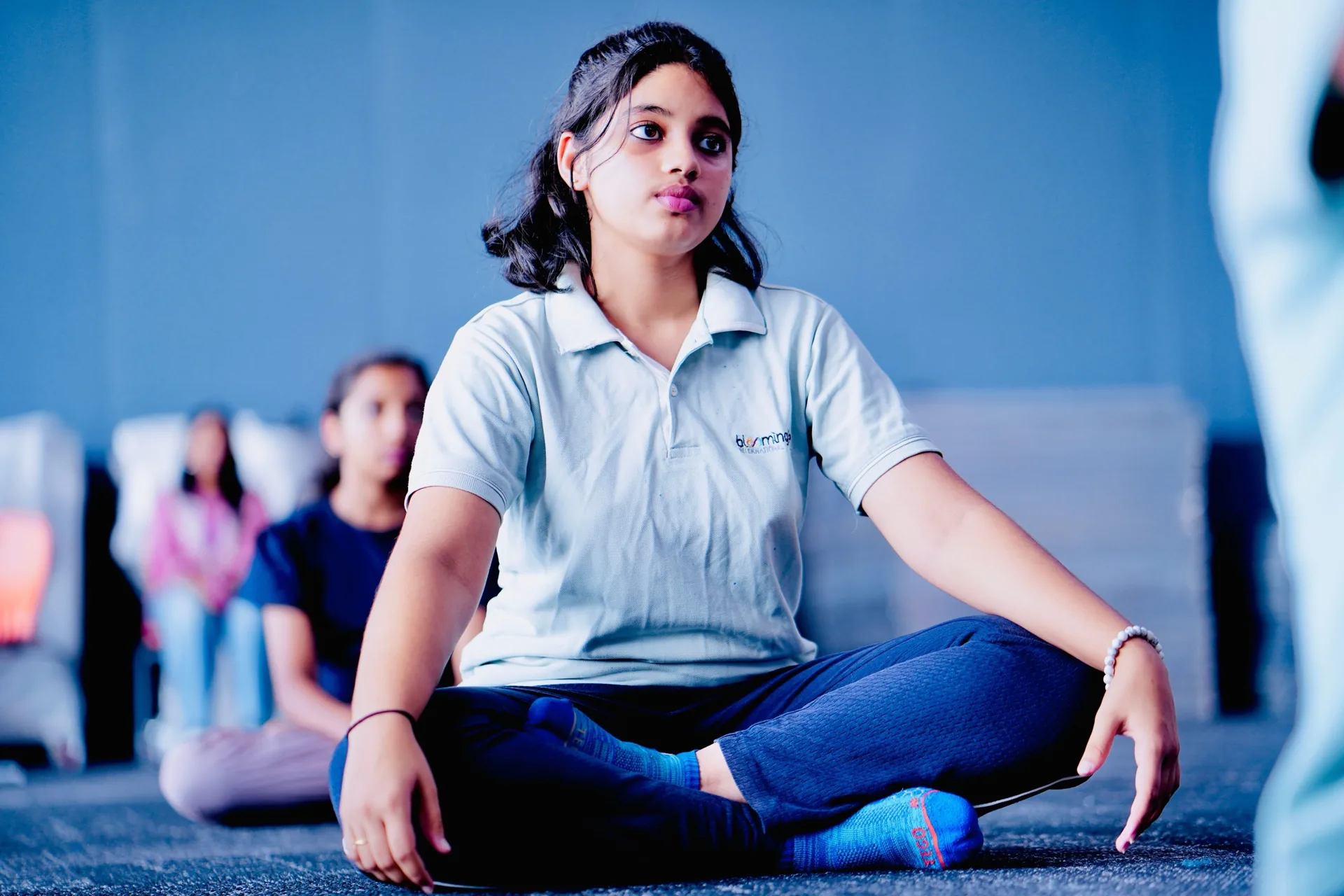 A student seated cross-legged during a session